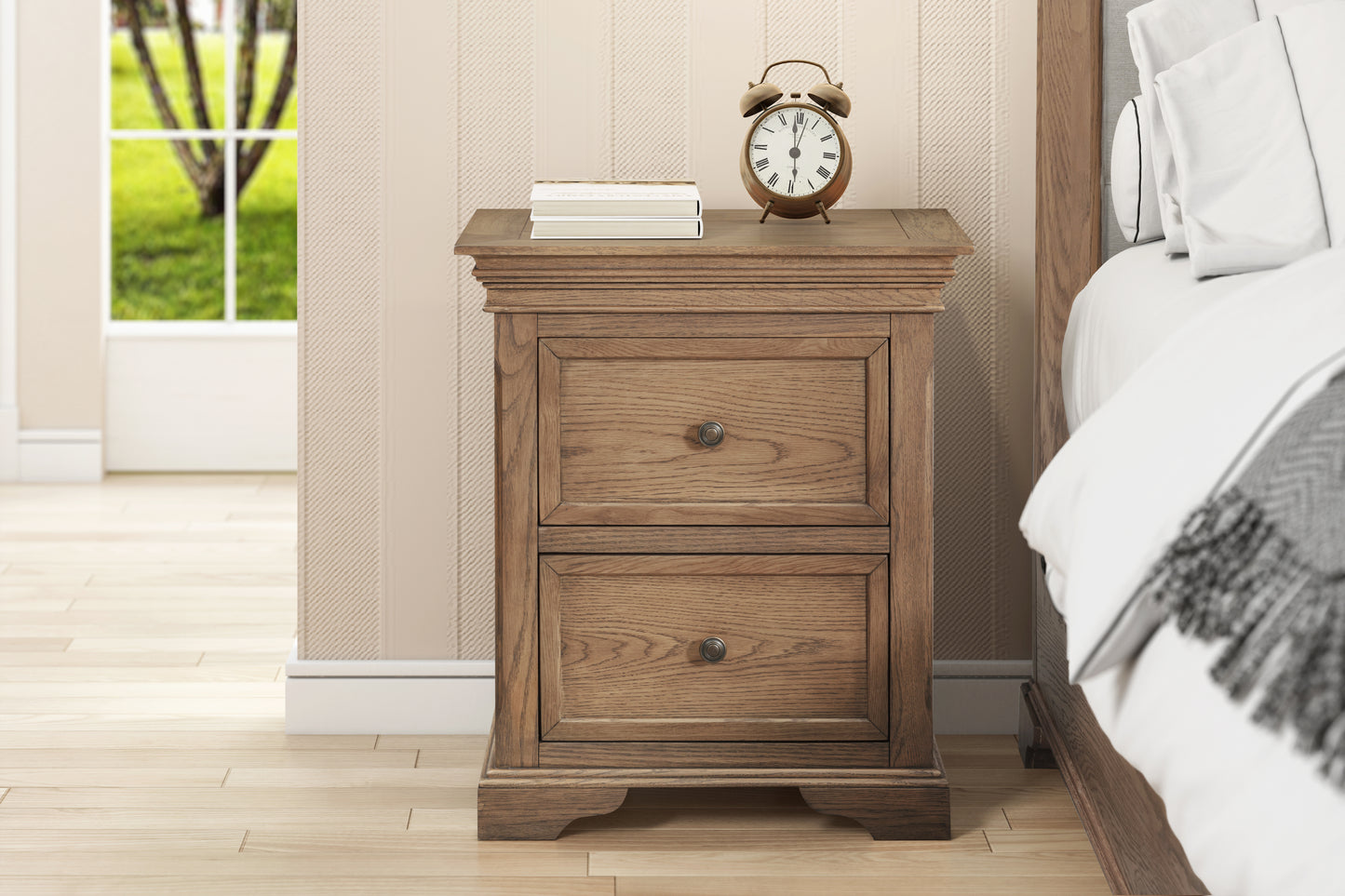 Wooden nightstand with two drawers next to a bed in a bedroom.