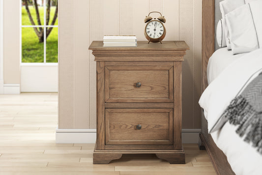 Wooden nightstand with two drawers next to a bed in a bedroom.